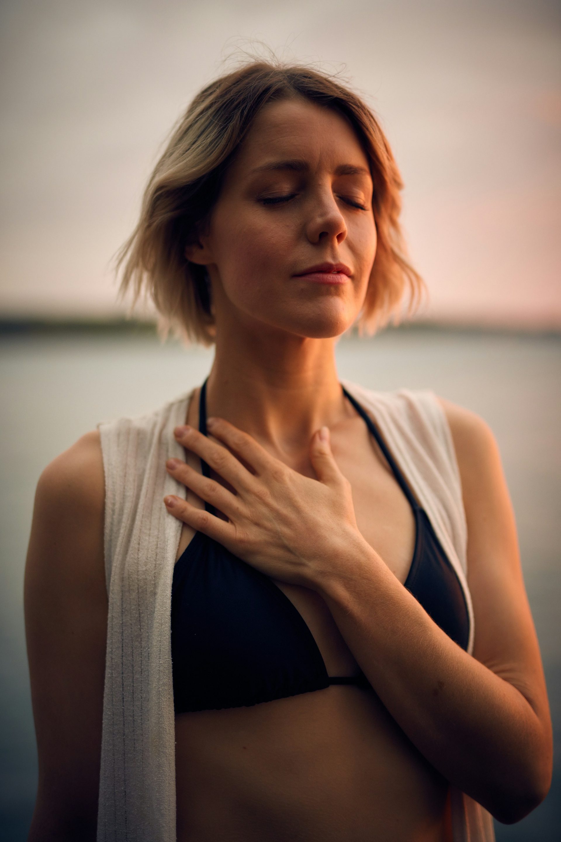 A woman at ease, hand on her chest