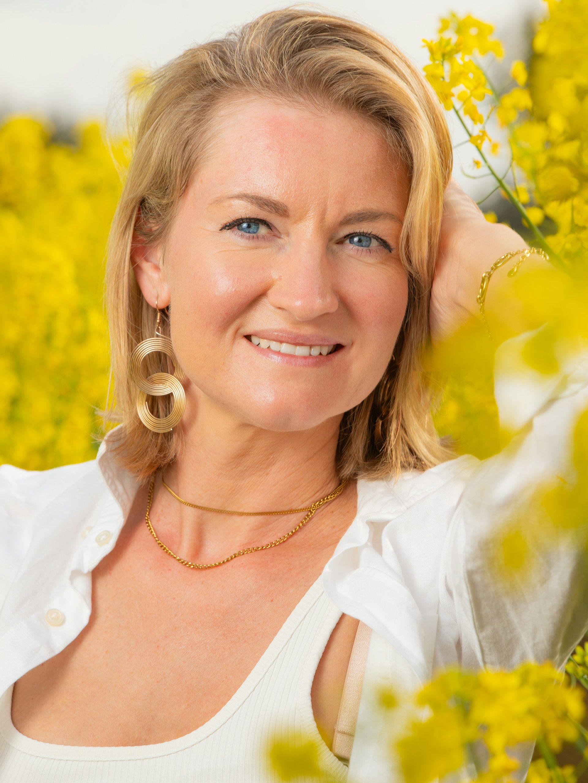 A woman with glowing skin, smiling in the sun