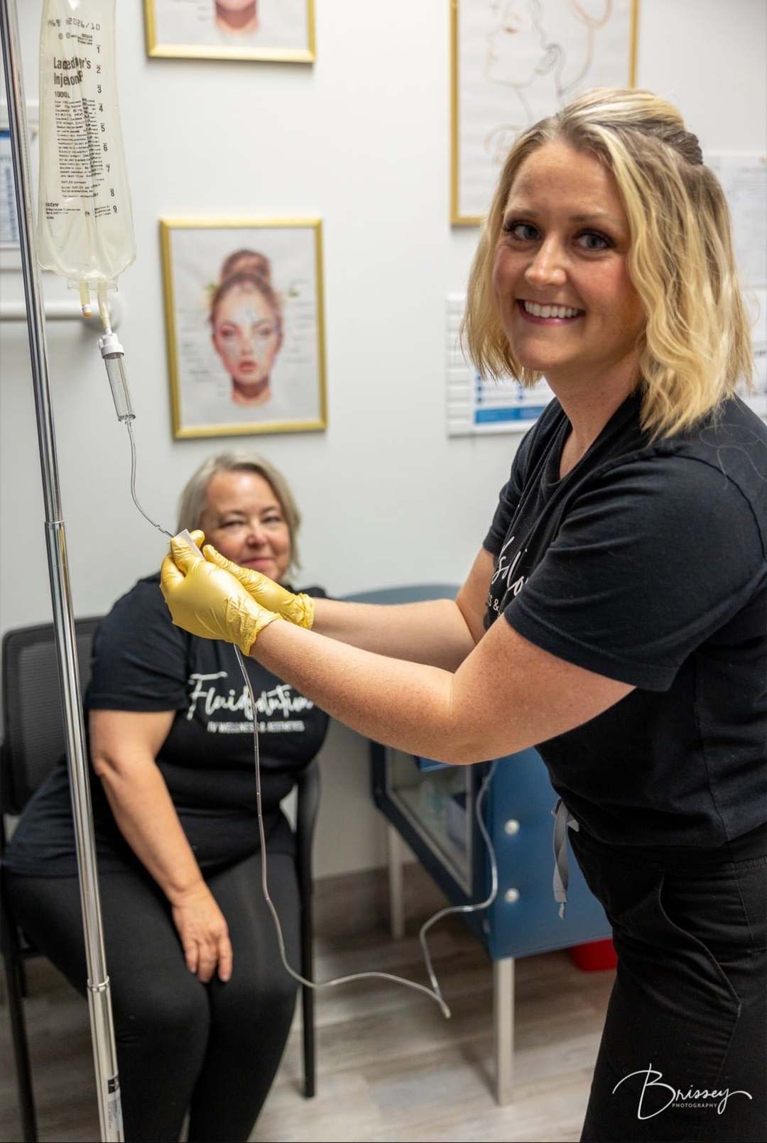 Amanda with a patient, a drip running